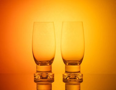 Gözlük ve şişeler de dahil olmak üzere, büyüleyici ve canlı bir vitrin, renkli ışıklarla güzelce aydınlatılmış, büyüleyici ve canlı bir görsel kompozisyon yaratıyor..