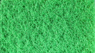 Tasarım projeleri, dokuları ve yaratıcı uygulamalar için çok yönlü ve soyut bir arkaplan sağlayan ince desenli yeşil bir kumaşın yakın çekimi.