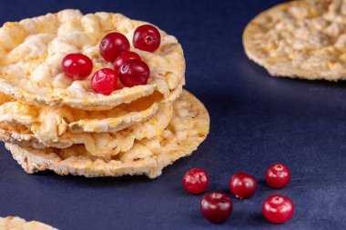 A delightful stack of wholesome corn pancakes topped with a generous helping of vibrant cranberries, providing a nourishing and satisfying start to your day. clipart