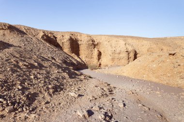 The dried up river bed - the path to the Red Canyon, in the national reserve - the Red Canyon in the rays of the setting sun, near the city of Eilat, in southern Israel.