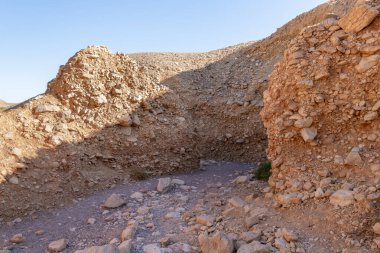 The dried up river bed - the path to the Red Canyon, in the national reserve - the Red Canyon in the rays of the setting sun, near the city of Eilat, in southern Israel.