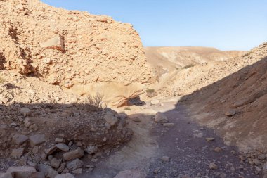 The dried up river bed - the path to the Red Canyon, in the national reserve - the Red Canyon in the rays of the setting sun, near the city of Eilat, in southern Israel.