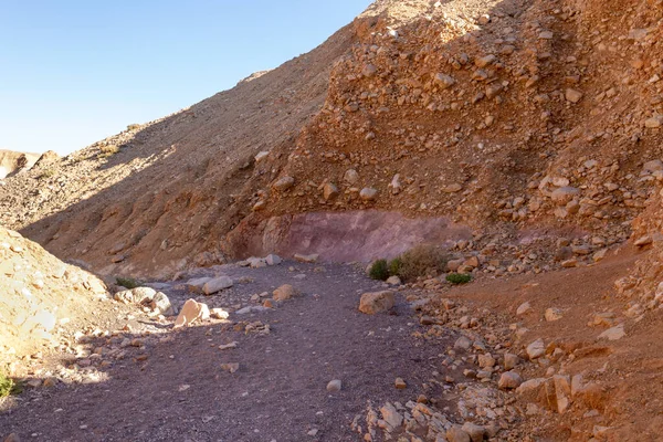 The dried up river bed - the path to the Red Canyon, in the national reserve - the Red Canyon in the rays of the setting sun, near the city of Eilat, in southern Israel.