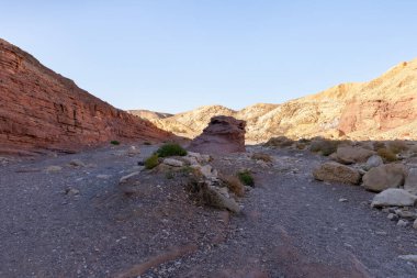 Fantastically beautiful landscape in the national nature reserve - Red Canyon in the rays of the setting sun, near the city of Eilat, in southern Israel
