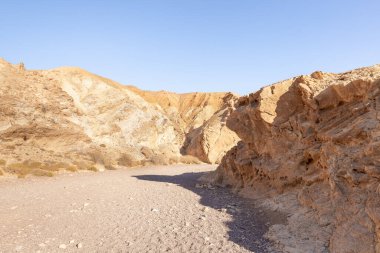 The dried up river bed - the path to the Red Canyon, in the national reserve - the Red Canyon in the rays of the setting sun, near the city of Eilat, in southern Israel.