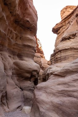 Fantastically beautiful landscape in the national nature reserve - Red Canyon in the rays of the setting sun, near the city of Eilat, in southern Israel