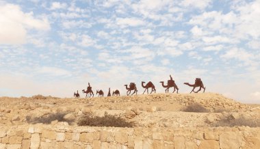 Mitzpe Ramon, Israel, December 14, 2022 : Abstract caravan made of iron near ruins of Nabatean fortress city Avdat, on trade route called Road of Incense, near Mitzpe Ramon city, in southern Israel