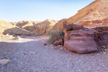 Fantastically beautiful landscape in the national nature reserve - Red Canyon in the rays of the setting sun, near the city of Eilat, in southern Israel