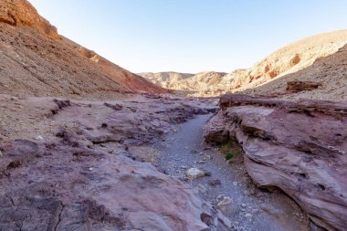 Fantastically beautiful landscape in the national nature reserve - Red Canyon in the rays of the setting sun, near the city of Eilat, in southern Israel