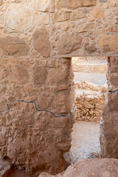 The remains of internal buildings in the rays of the rising sun in the ruins of the fortress of Masada - is a fortress built by Herod the Great on a cliff-top off the coast of the Dead Sea, in southern Israel