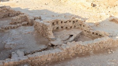 The remains of internal buildings in the rays of the rising sun in the ruins of the fortress of Masada - is a fortress built by Herod the Great on a cliff-top off the coast of the Dead Sea, in southern Israel