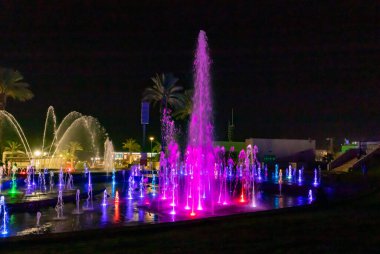 Eilat, Israel, December 13, 2022 : Enchanting grandiose musical performance - water and light show of a musical fountain on the embankment, in the center of the city of Eilat in southern Israel