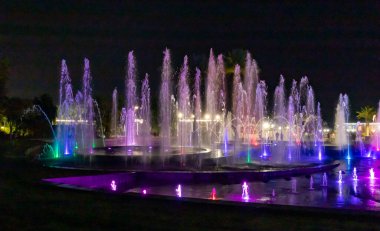 Eilat, Israel, December 13, 2022 : Enchanting grandiose musical performance - water and light show of a musical fountain on the embankment, in the center of the city of Eilat in southern Israel
