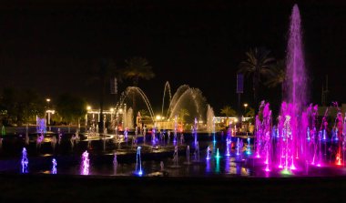 Eilat, Israel, December 13, 2022 : Enchanting grandiose musical performance - water and light show of a musical fountain on the embankment, in the center of the city of Eilat in southern Israel