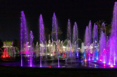 Eilat, Israel, December 13, 2022 : Enchanting grandiose musical performance - water and light show of a musical fountain on the embankment, in the center of the city of Eilat in southern Israel