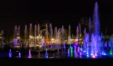 Eilat, Israel, December 13, 2022 : Enchanting grandiose musical performance - water and light show of a musical fountain on the embankment, in the center of the city of Eilat in southern Israel