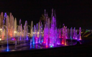 Eilat, Israel, December 13, 2022 : Enchanting grandiose musical performance - water and light show of a musical fountain on the embankment, in the center of the city of Eilat in southern Israel