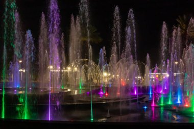 Eilat, Israel, December 13, 2022 : Enchanting grandiose musical performance - water and light show of a musical fountain on the embankment, in the center of the city of Eilat in southern Israel