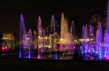 Eilat, Israel, December 13, 2022 : Enchanting grandiose musical performance - water and light show of a musical fountain on the embankment, in the center of the city of Eilat in southern Israel