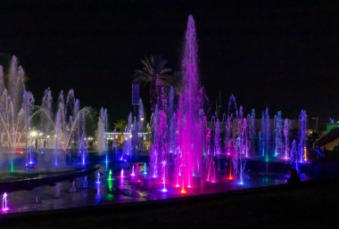 Eilat, Israel, December 13, 2022 : Enchanting grandiose musical performance - water and light show of a musical fountain on the embankment, in the center of the city of Eilat in southern Israel