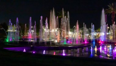 Eilat, Israel, December 13, 2022 : Enchanting grandiose musical performance - water and light show of a musical fountain on the embankment, in the center of the city of Eilat in southern Israel