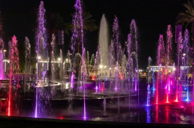 Eilat, Israel, December 13, 2022 : Enchanting grandiose musical performance - water and light show of a musical fountain on the embankment, in the center of the city of Eilat in southern Israel