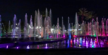 Eilat, Israel, December 13, 2022 : Enchanting grandiose musical performance - water and light show of a musical fountain on the embankment, in the center of the city of Eilat in southern Israel