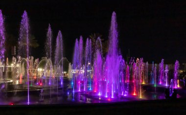 Eilat, Israel, December 13, 2022 : Enchanting grandiose musical performance - water and light show of a musical fountain on the embankment, in the center of the city of Eilat in southern Israel