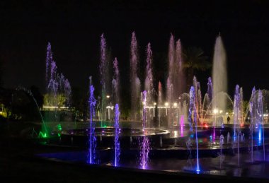 Eilat, Israel, December 13, 2022 : Enchanting grandiose musical performance - water and light show of a musical fountain on the embankment, in the center of the city of Eilat in southern Israel