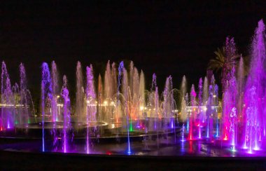 Eilat, Israel, December 13, 2022 : Enchanting grandiose musical performance - water and light show of a musical fountain on the embankment, in the center of the city of Eilat in southern Israel