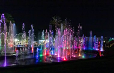 Eilat, Israel, December 13, 2022 : Enchanting grandiose musical performance - water and light show of a musical fountain on the embankment, in the center of the city of Eilat in southern Israel