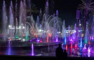Eilat, Israel, December 13, 2022 : Enchanting grandiose musical performance - water and light show of a musical fountain on the embankment, in the center of the city of Eilat in southern Israel