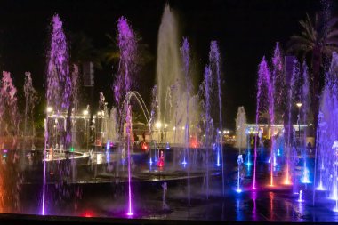 Eilat, Israel, December 13, 2022 : Enchanting grandiose musical performance - water and light show of a musical fountain on the embankment, in the center of the city of Eilat in southern Israel