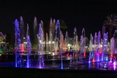 Eilat, Israel, December 13, 2022 : Enchanting grandiose musical performance - water and light show of a musical fountain on the embankment, in the center of the city of Eilat in southern Israel