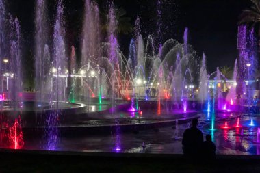 Eilat, Israel, December 13, 2022 : Enchanting grandiose musical performance - water and light show of a musical fountain on the embankment, in the center of the city of Eilat in southern Israel