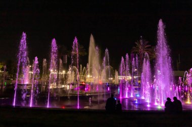Eilat, Israel, December 13, 2022 : Enchanting grandiose musical performance - water and light show of a musical fountain on the embankment, in the center of the city of Eilat in southern Israel