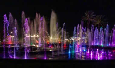 Eilat, Israel, December 13, 2022 : Enchanting grandiose musical performance - water and light show of a musical fountain on the embankment, in the center of the city of Eilat in southern Israel