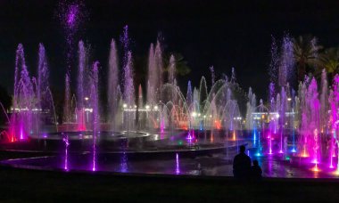 Eilat, Israel, December 13, 2022 : Enchanting grandiose musical performance - water and light show of a musical fountain on the embankment, in the center of the city of Eilat in southern Israel