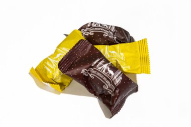 Birleşik Arap Emirlikleri 'nin geleneksel lezzetlerinden birkaçı çikolata kaplı, fındıklı, sarı ve kahverengi paketlerde beyaz arka planda.