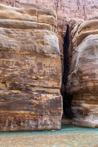 Color diversity of mountain rocks at beginning of tourist route in the Mujib River Canyon in Wadi Al Mujib in Jordan