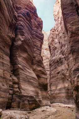 A small shallow stream flows along hiking trail in the Wadi Numeira gorge in Jordan