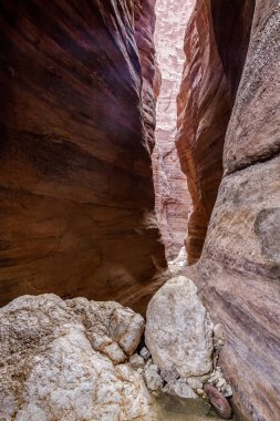 High cliffs with beautiful natural patterns along walking trail in Wadi Numeira gorge in Jordan