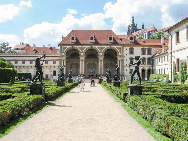 stock image Prague, Czech Republic, July 31, 2010 : Tourists walk along the decorative alley decorated with many statues in a decorative park at Wallenstein Palace building in Prague in Czech Republic