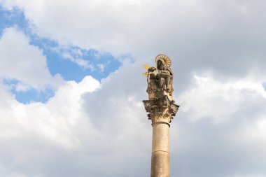 Prague, Czech Republic, May 12, 2024 : Top of the column on the wall combines the Pieta of the Virgin Mary with the dead Christ on the Royal Road in Prague in Czech Republic clipart