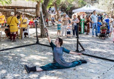 Jerusalem, Israel, October 03, 2024 : Festival participant shows show with Japanese sword at annual festival Jerusalem Knights 2024 in Jerusalem Israel clipart