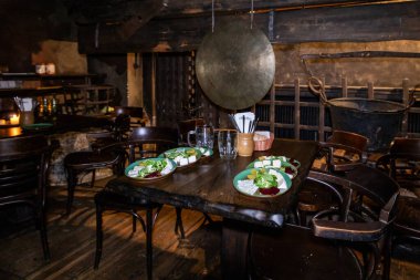 Prag, Çek Cumhuriyeti, 12 Mayıs 2024: Çek Cumhuriyeti 'nin Prag' ın eski bir kesimindeki ortaçağ taverna restoranı U Pavouka 'da ziyaretçileri bekleyen masalar