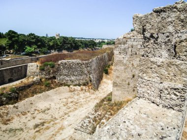 A well preserved moat between the fortress walls in historic part of Rhodes city on Rhodes island in Greece clipart