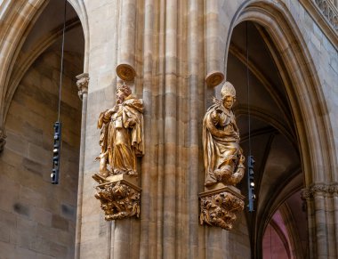 Prag, Çek Cumhuriyeti, 14 Mayıs 2024: Çek Cumhuriyeti 'nin Prag kentindeki Aziz Vitus Katedrali' nin ana salonundaki sütunların üzerindeki altın heykeller