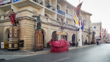 Ir Rabat, Malta, 04 July, 2013 : Various statues against backdrop of ancient houses in square in historical part of Ir Rabat old city in Malta
