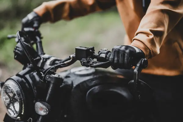 Orman yolunda motosikletli bir adam.